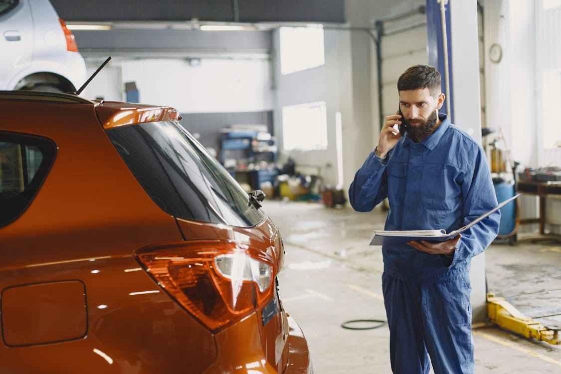 Mechanic on phone in garage